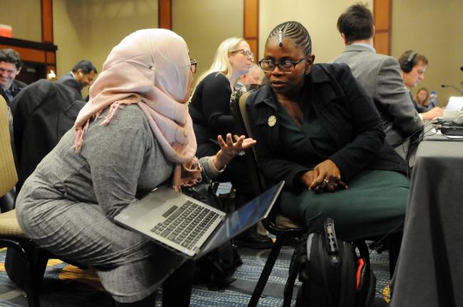 Delegates confer during the session