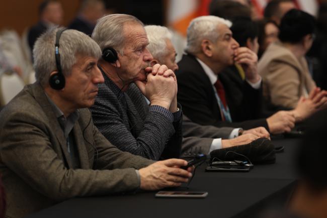 Delegates listen to the interventions