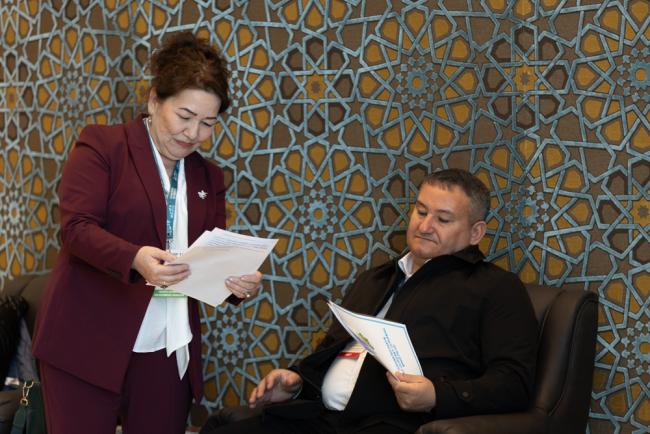 Delegates speak informally between sessions