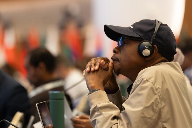 Delegates listen to the deliberations