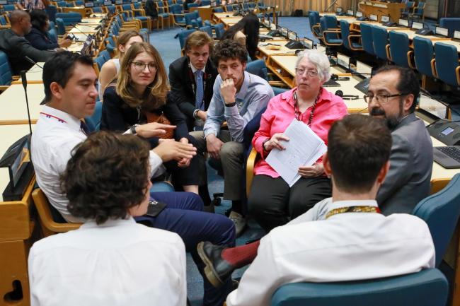 Delegates discussing a draft resolution between Working Group sessions.