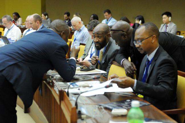 Delegates from the African region confer during the session
