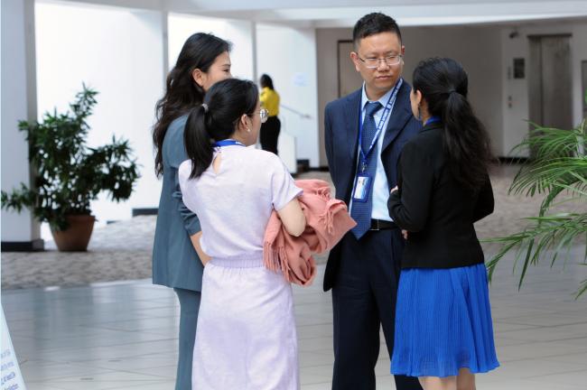 Delegates from China confer outside the meeting room