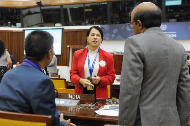 Elza Moreira Marcelino de Castro, Brazil, confers with Masakuu Rungsung and Sandip Mukhopadhyay, India