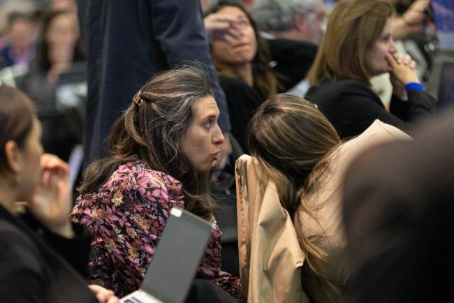 Delegates consult informally following delays with the technical system