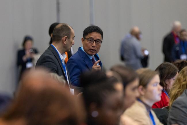 Delegates speak informally between sessions