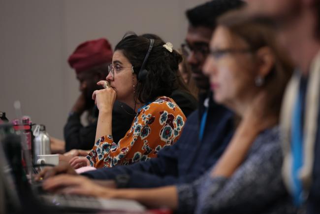 Delegates listen to the deliberations