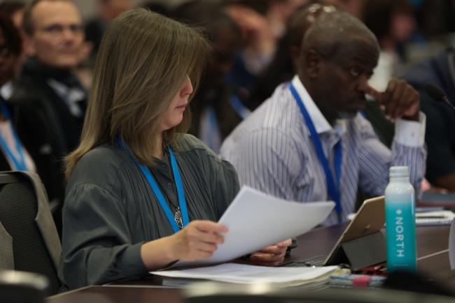 Delegates review the text under discussion