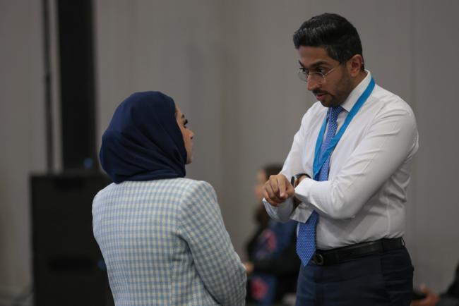 Mohammed Albarrak, Saudi Arabia, speaks with a delegate