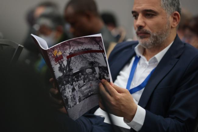 Delegates refer to different texts during the session