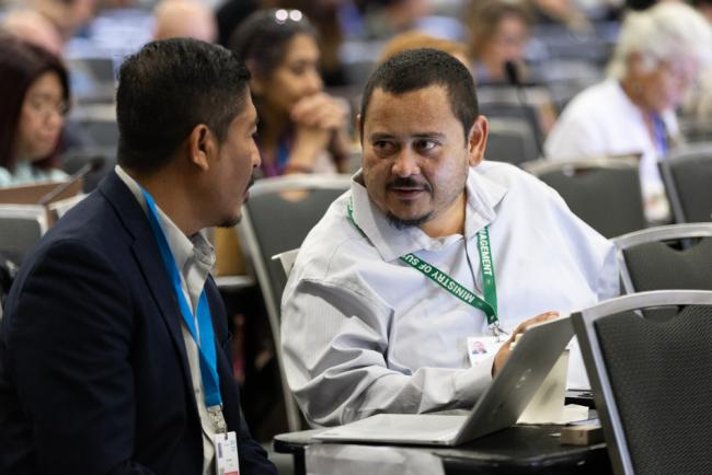 Delegates from Belize consult during the session