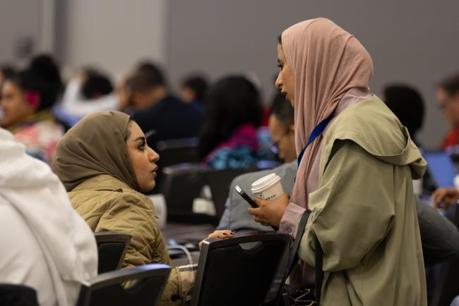 Delegates consult during the session