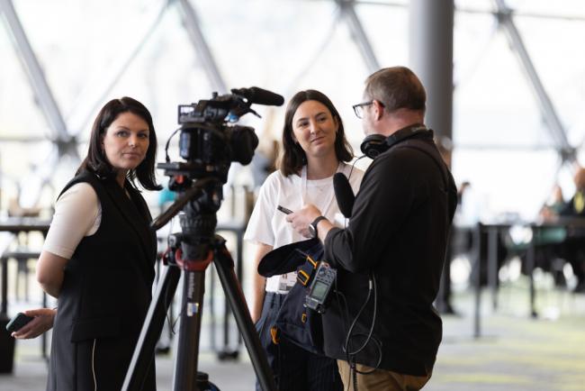 Delegates conduct interviews around the venue