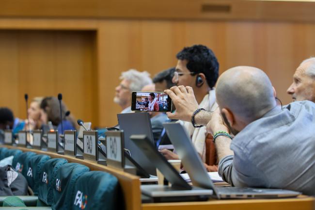 A delegate taking a video 