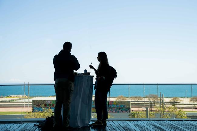 people eating lunch with an ocean view as a backdrop 