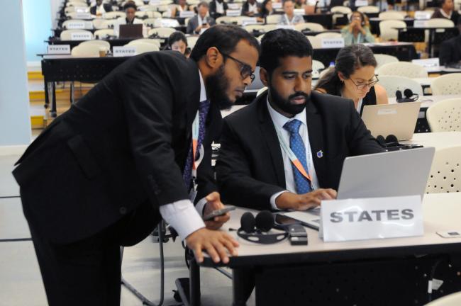 Delegates confer during the session