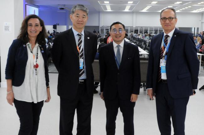 Participants pose for a photo during plenary