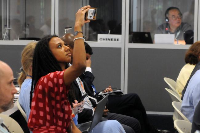 A participant records the intervention by Richard Benyon, Minister of State for Climate, Environment and Energy, UK