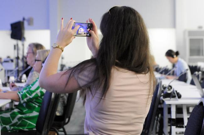 Participant takes a photo of Xavier Castellanos Mosquera, International Federation of Red Cross and Red Crescent Societies (IFRC)
