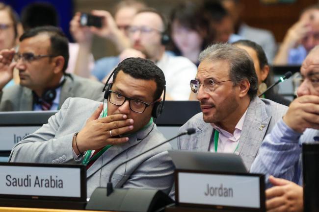 Delegates from Saudi Arabia conferring
