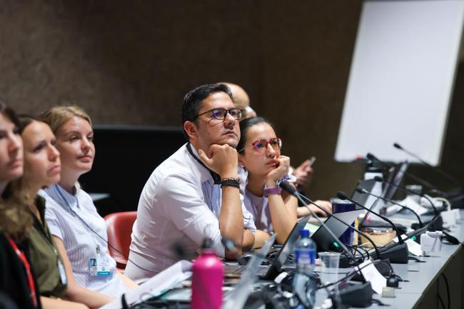 Delegates listen to the deliberations 