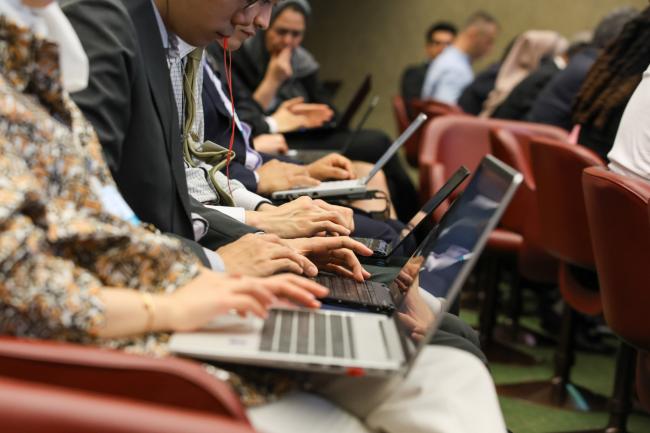 Delegates taking notes