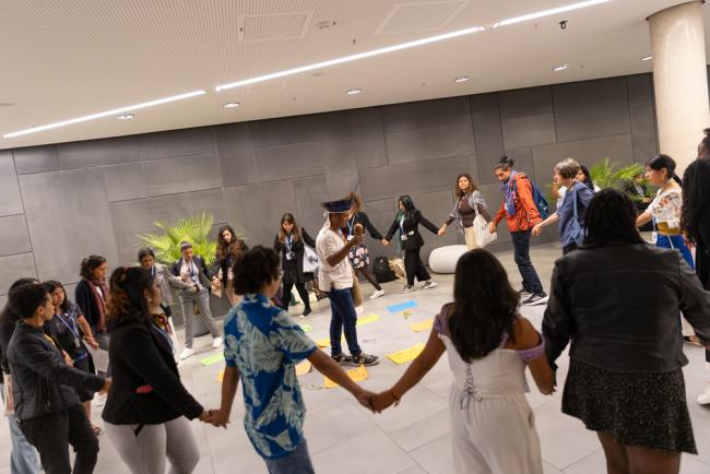 Members of civil society demonstrate in the corridors, calling for, among other things, a greater respect to be paid to Indigenous Peoples