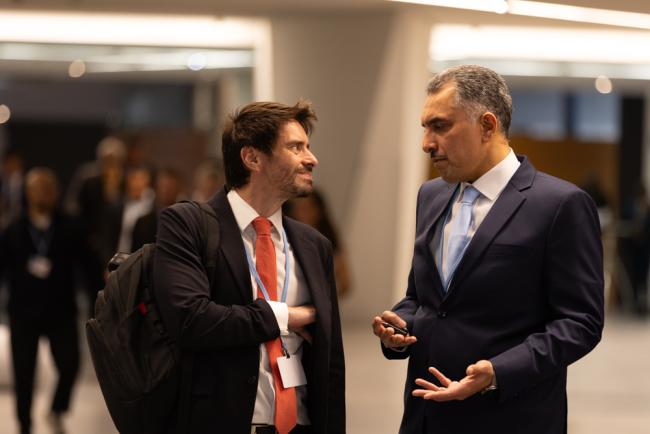 Delegates from Brazil and Saudi Arabia speak informally