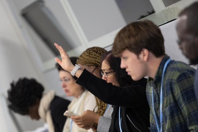 Delegates ask questions from the floor