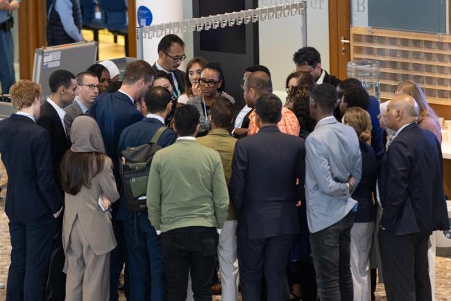 Delegates huddle during the informal consultations on matters relating to Least Developed Countries (LDCs)
