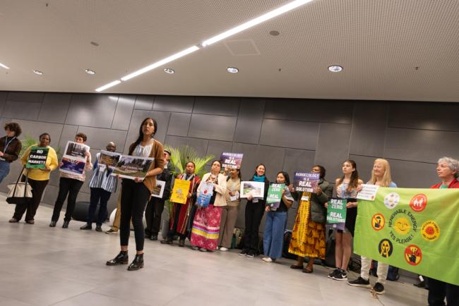 Members of civil society demonstrate in the corridors, calling for 'no false finance for false solutions'