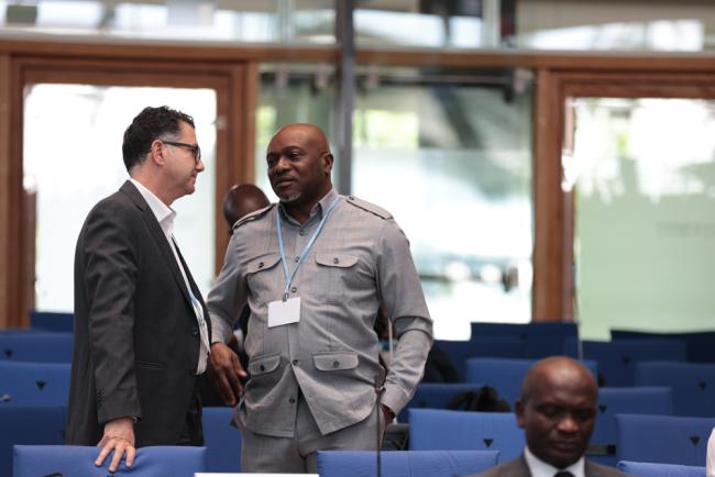 Mohamed Nasr, Egypt, speaks with Tosi Mpanu-Mpanu, Democratic Republic of the Congo