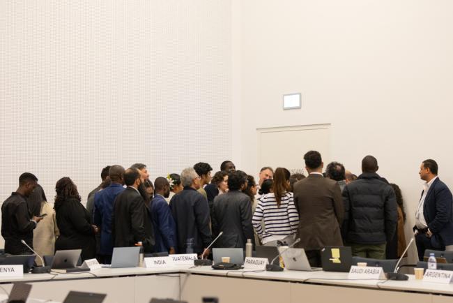 Members of G-77/China huddle during the informal consultations on the enhanced transparency framework