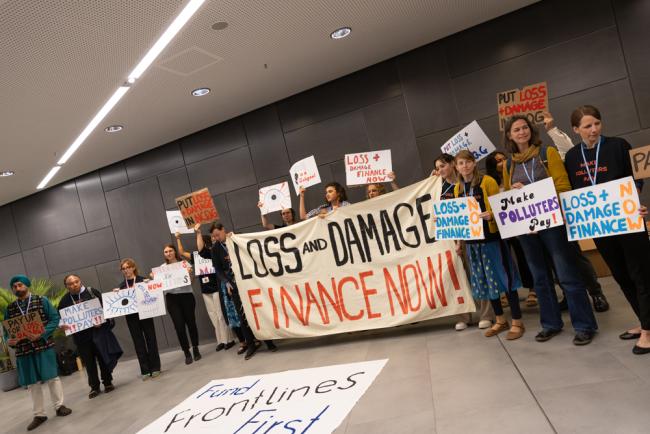 Members of civil society demonstrate in the corridors, calling for financing for loss and damage and for polluters to pay up
