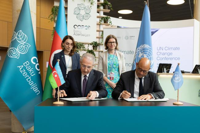 COP 29 President-designate Mukhtar Babayev, Minister of Ecology and Natural Resources, Azerbaijan, and UNFCCC Executive Secretary Simon Stiell, sign one of the legal instruments for the upcoming COP 29