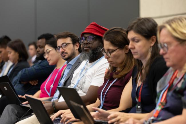 Delegates listen during an informal