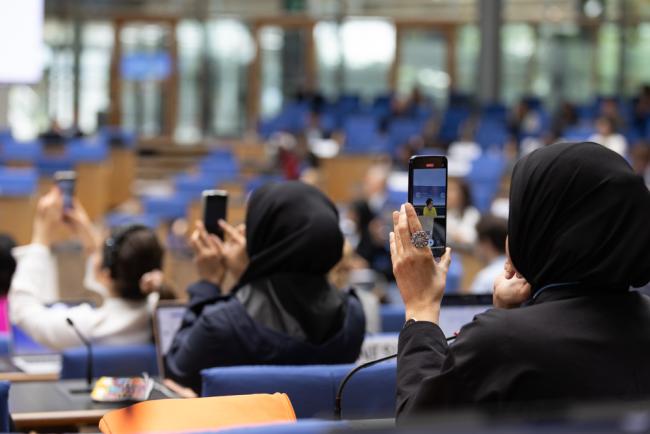 Delegates take photos