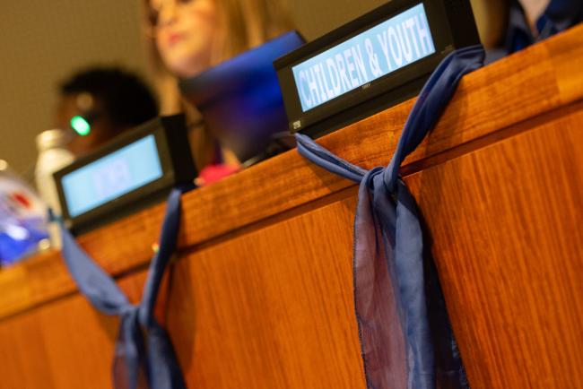 Blue scarves decorate the venue as the Women's Major Group highlights that there is 'no feminism in militarization', and demand peace and rights migrant and refugee women