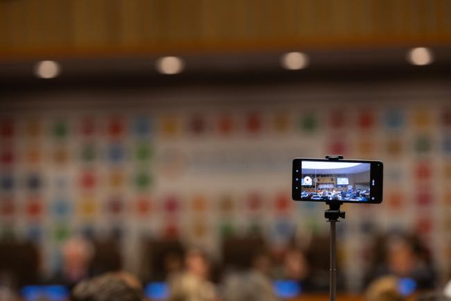 A delegate records the discussion on overcoming barriers in middle-income countries