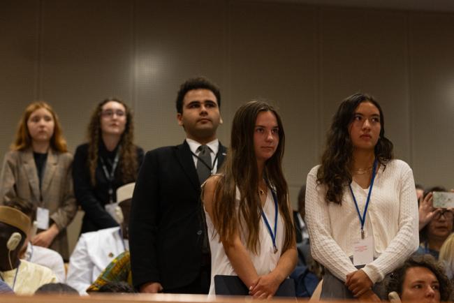 Youth delegates stand in solidarity as the representative from the Major Group for Children and Youth delivers her statement