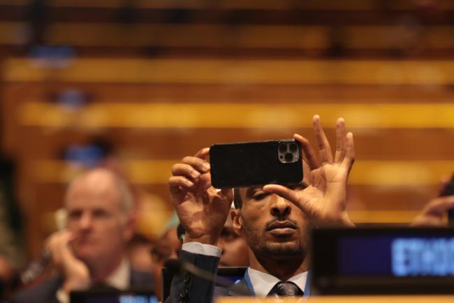 Delegates record the performance