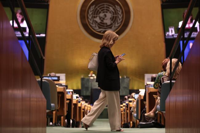 A delegate walks through the UN General Assembly hall at the start of the High-level Segment