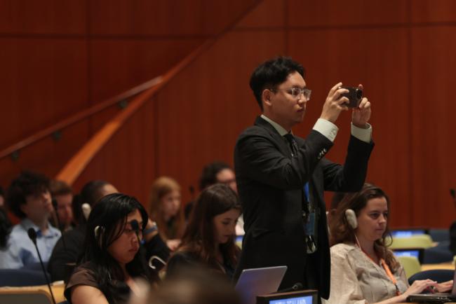 A delegate takes photos