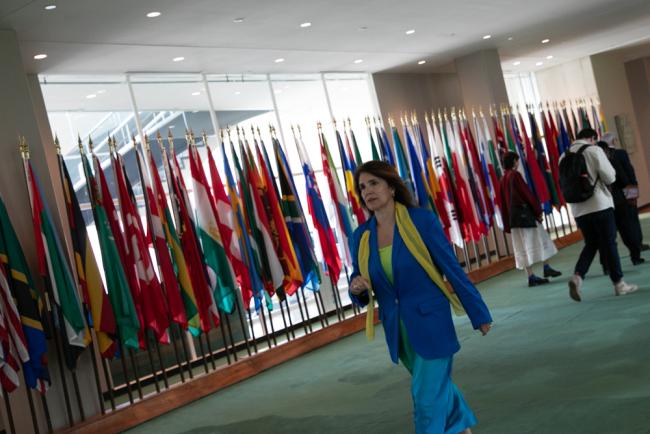 Paula Narváez, Vice President, ECOSOC, walks through the venue wearing a yellow scarf, symbolizing the need to commit to economic justice, equal pay, and safe and inclusive work for all women