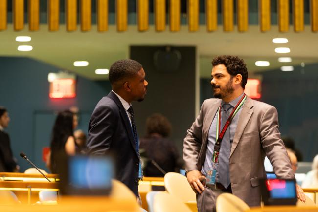 Delegates speak informally before the opening session