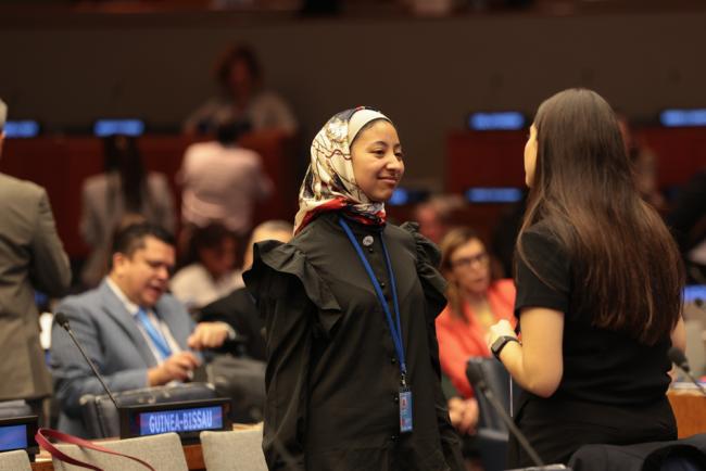 Delegates speak informally between sessions