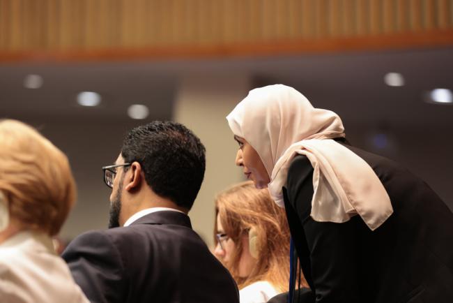 Delegates consult during the session