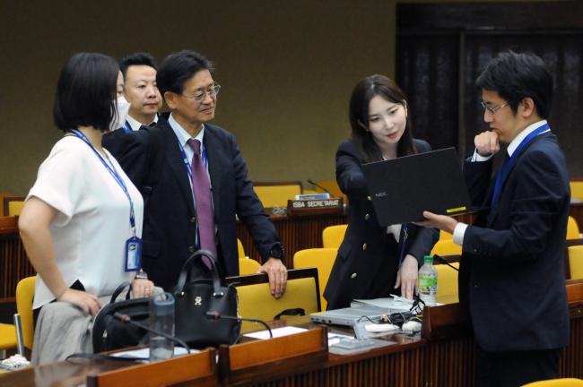 Delegates from Japan confer during a break