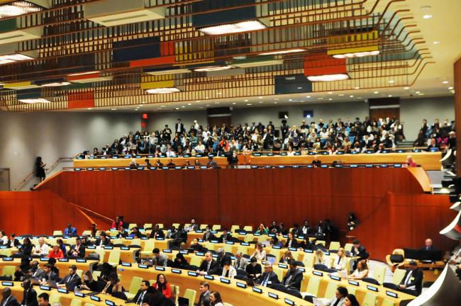 Delegates and participants follow the dialogue discussions