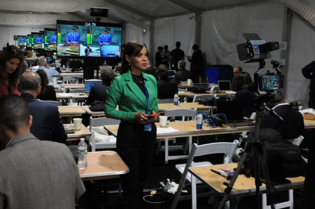 Journalists actively report from the media room